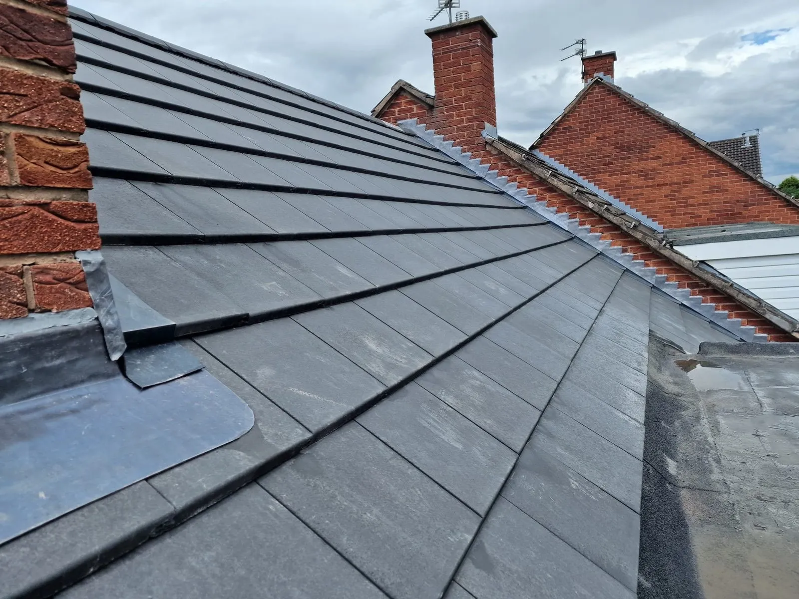 New slate tile roof fitted on a British semi-detached house