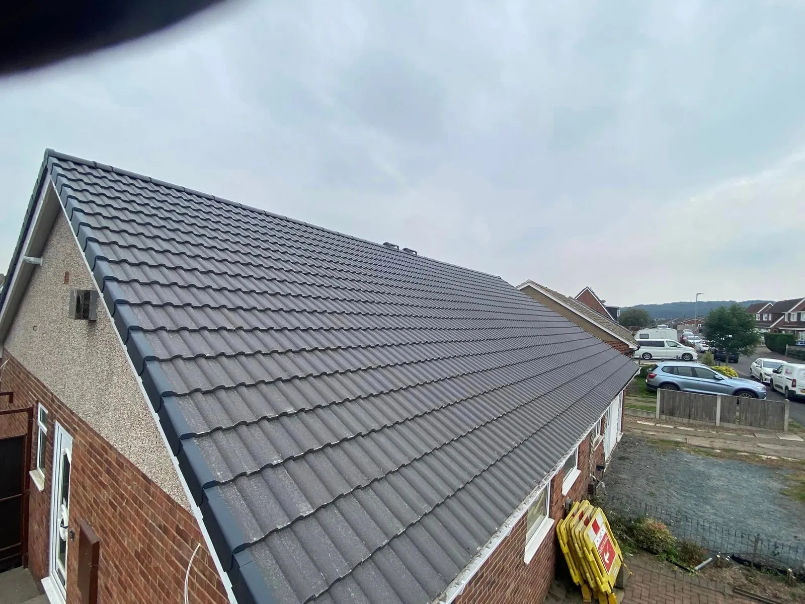 Dark slate roof replacement on a British brick house