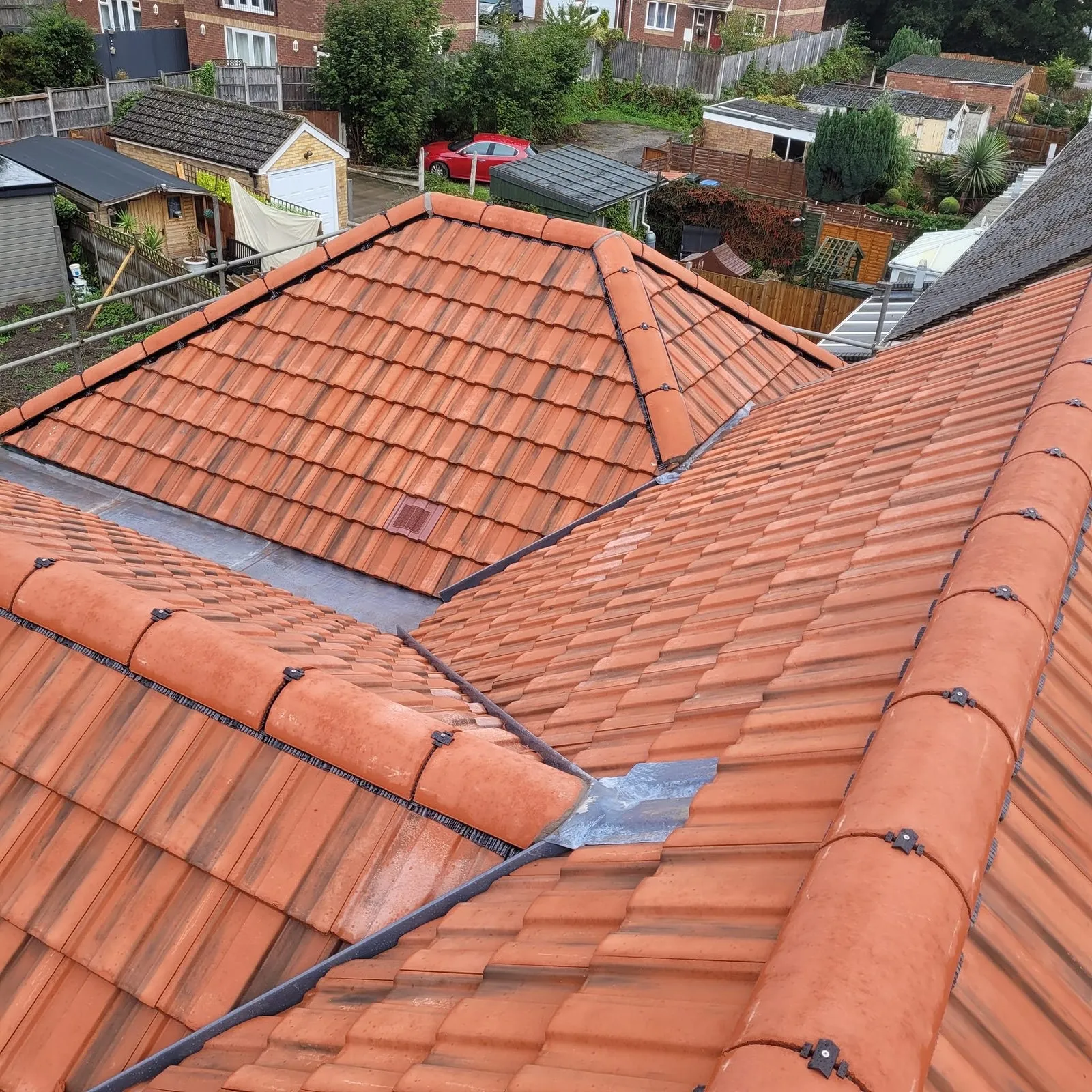 Emergency tarpaulin repair on a storm-damaged roof