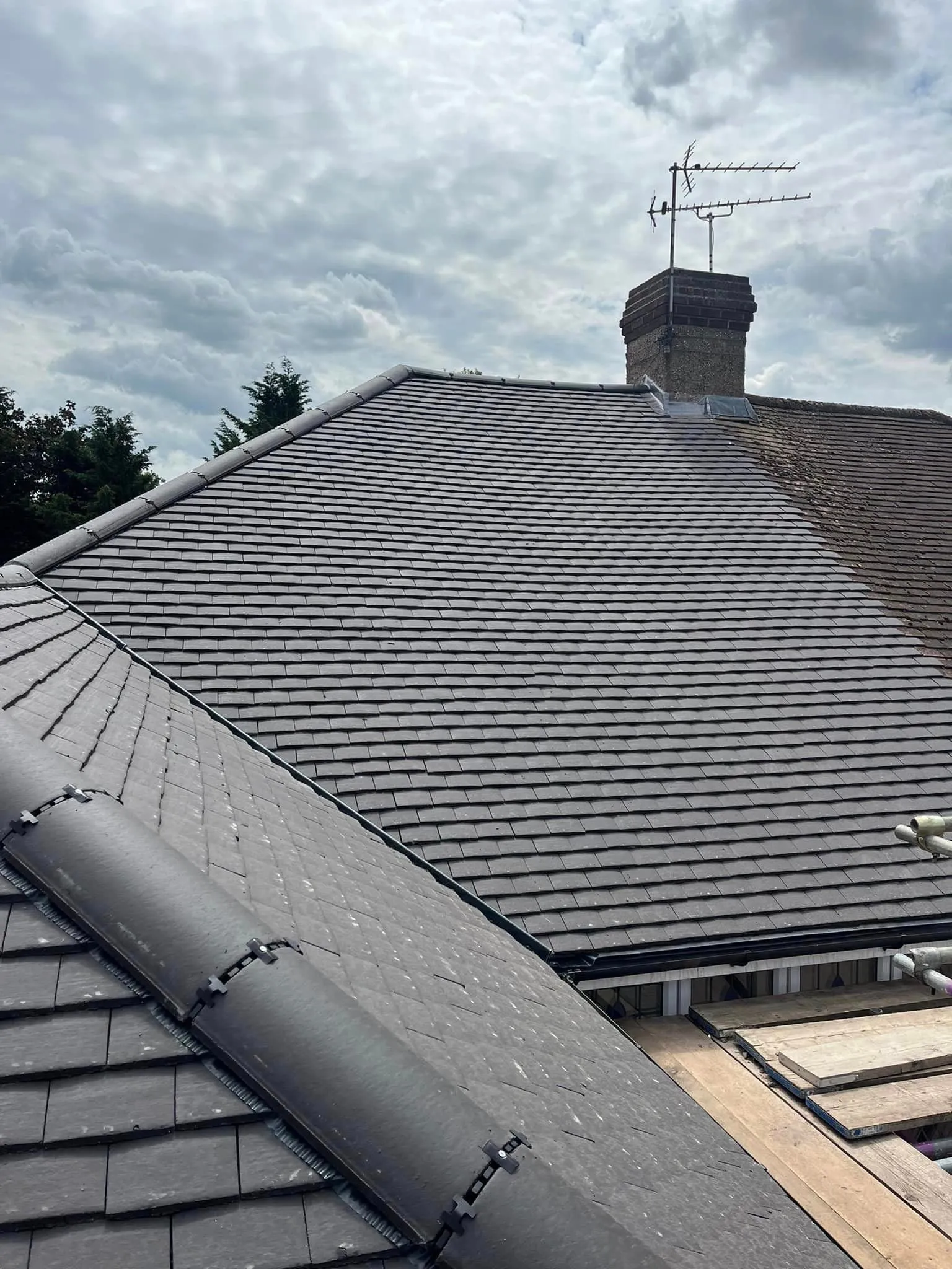 Slate roof installation with leadwork around the chimney